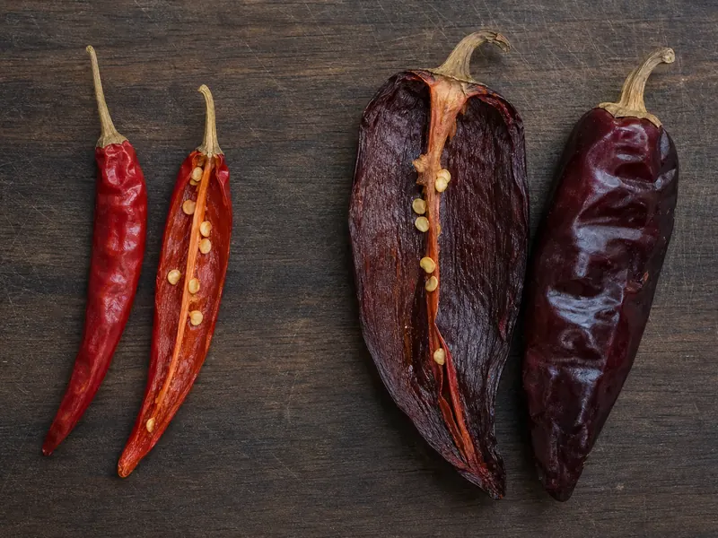 Opened chile de arbol and guajillo pods showing their different size and walls