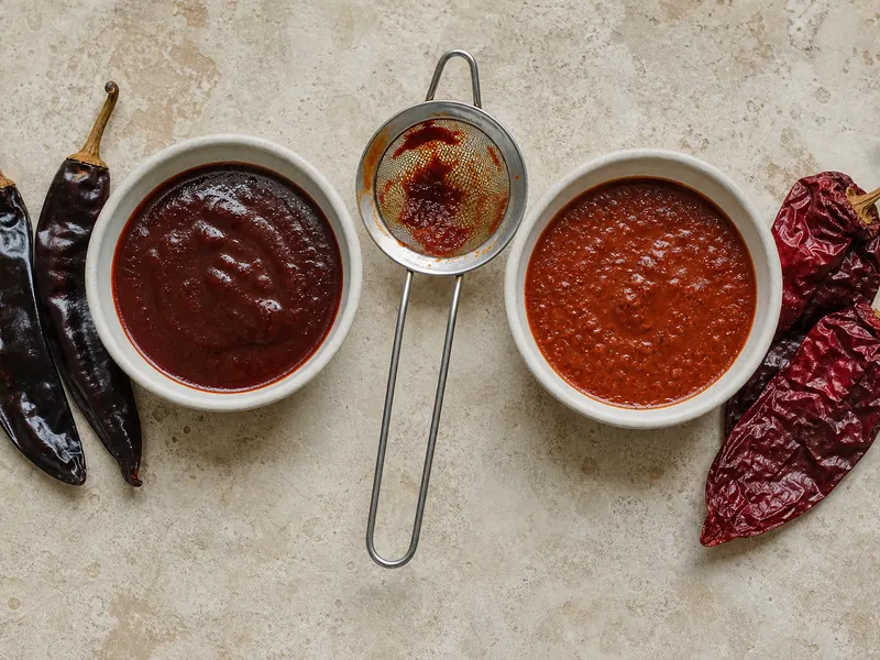 Rehydrated guajillo puree beside New Mexico red chile sauce