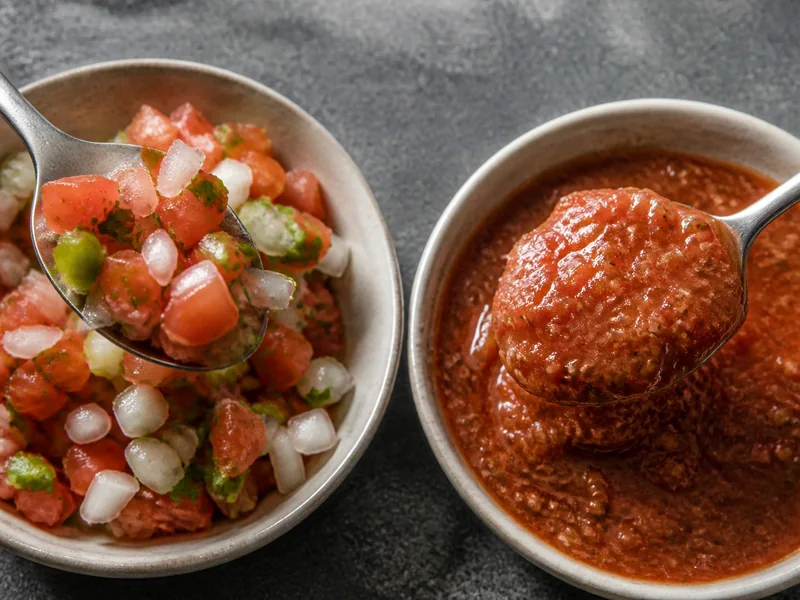 Spoons showing diced pico de gallo beside cohesive roasted salsa