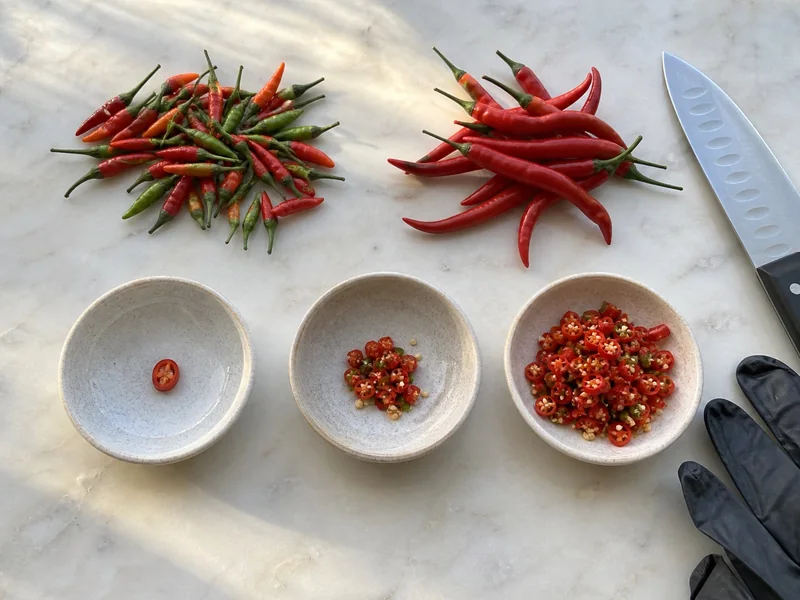 Tiny and long Thai chiles with three increasing measured portions